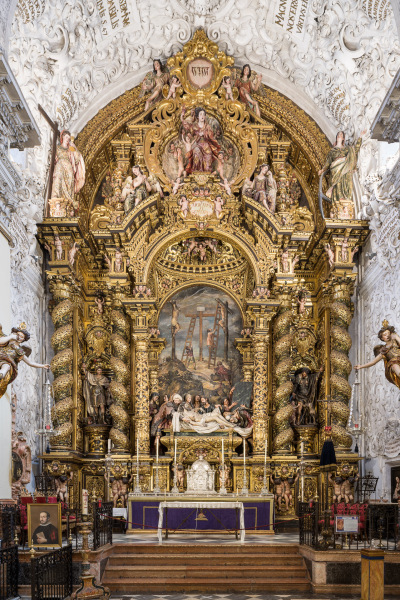 The Baroque-style church of Hospital de la Santa Caridad (Capilla de San Jorge) was promoted by Miguel de Mañara in Seville, Spain and completed in 1670.The high altarpiece of the Charity, a masterpiece of the Spanish Baroque, shows the relief of Christ’s descent (Valdés Leal) and the sculpture group (Pedro Roldán), while the altarpiece was made by Bernardo Simón de Pineda and it's his best creation.